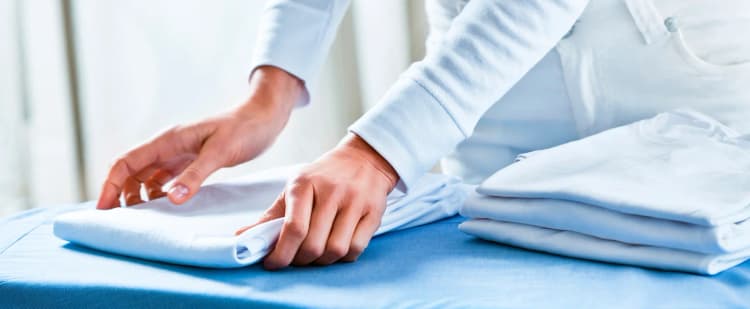Shirts being folded neatly after ironing